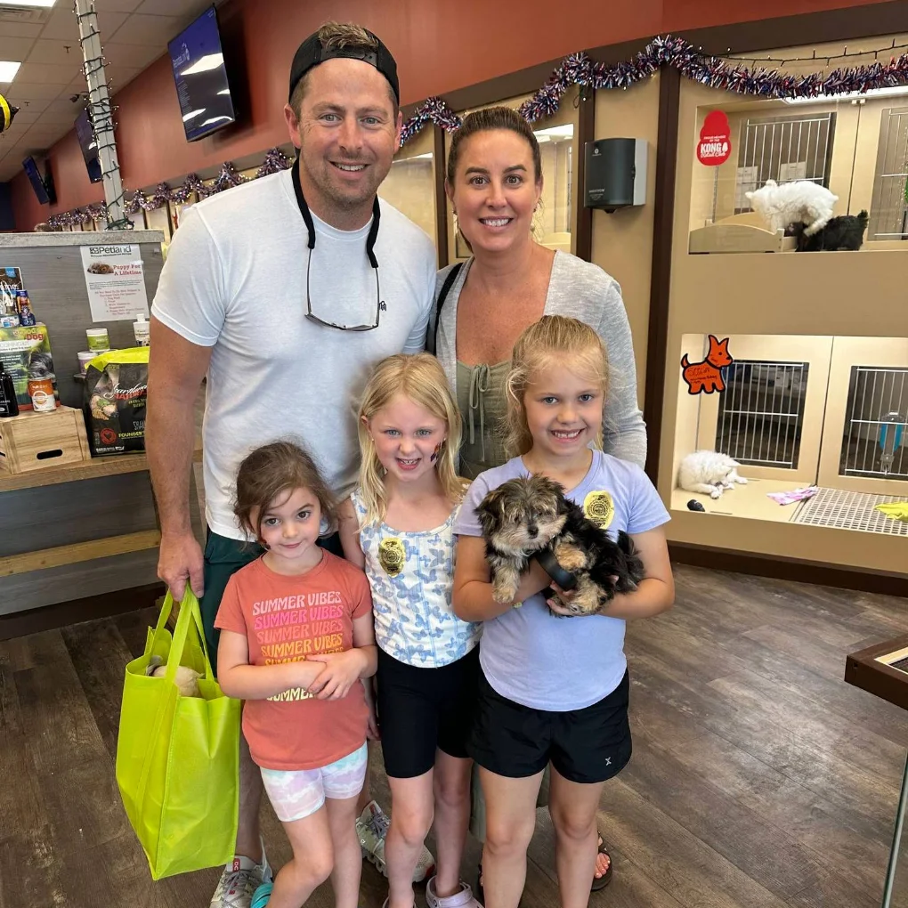 A family welcoming a puppy at Petland Iowa City